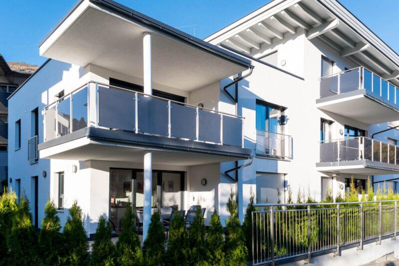 Man sieht das Haus im Sonnenschein, das Apartment 17 ist im ersten Stock, links